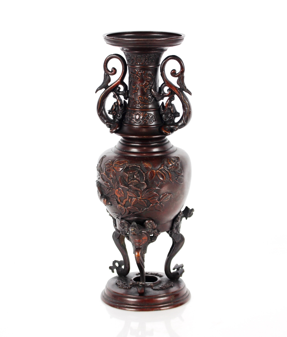 A Japanese Meiji period bronze vase, of baluster form flanked by dragon handles and birds below on
