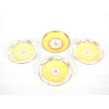 A 19th Century Derby yellow ground shallow dish; and three 19th Century Derby yellow and gilt