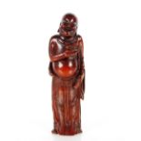 A 18th Century Chinese bamboo carving of a laughing man, holding toad in his right hand, 19cm high