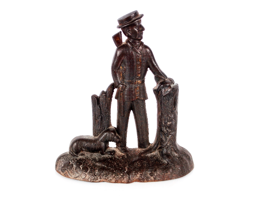 A Victorian cast iron door stop, in the form of a hunter and dog, 26cm high