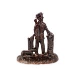 A Victorian cast iron door stop, in the form of a hunter and dog, 26cm high