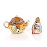 A small 19th Century bisque ware figure, of a seated nodding Oriental; and a Japanese tea pot of