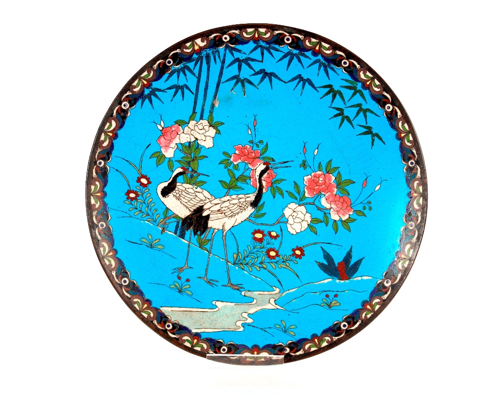 A late 19th / early 20th Century Japanese cloisonné charger, the blue field decorated cranes