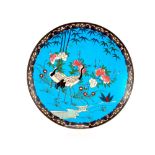 A late 19th / early 20th Century Japanese cloisonné charger, the blue field decorated cranes