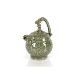 A Celadon Mystery water dropper, with mythical beast spout, serpent tail handle, the body in