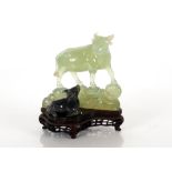 A Chinese carved Bowenite / hardstone study of a water buffalo, the largest beast standing upon