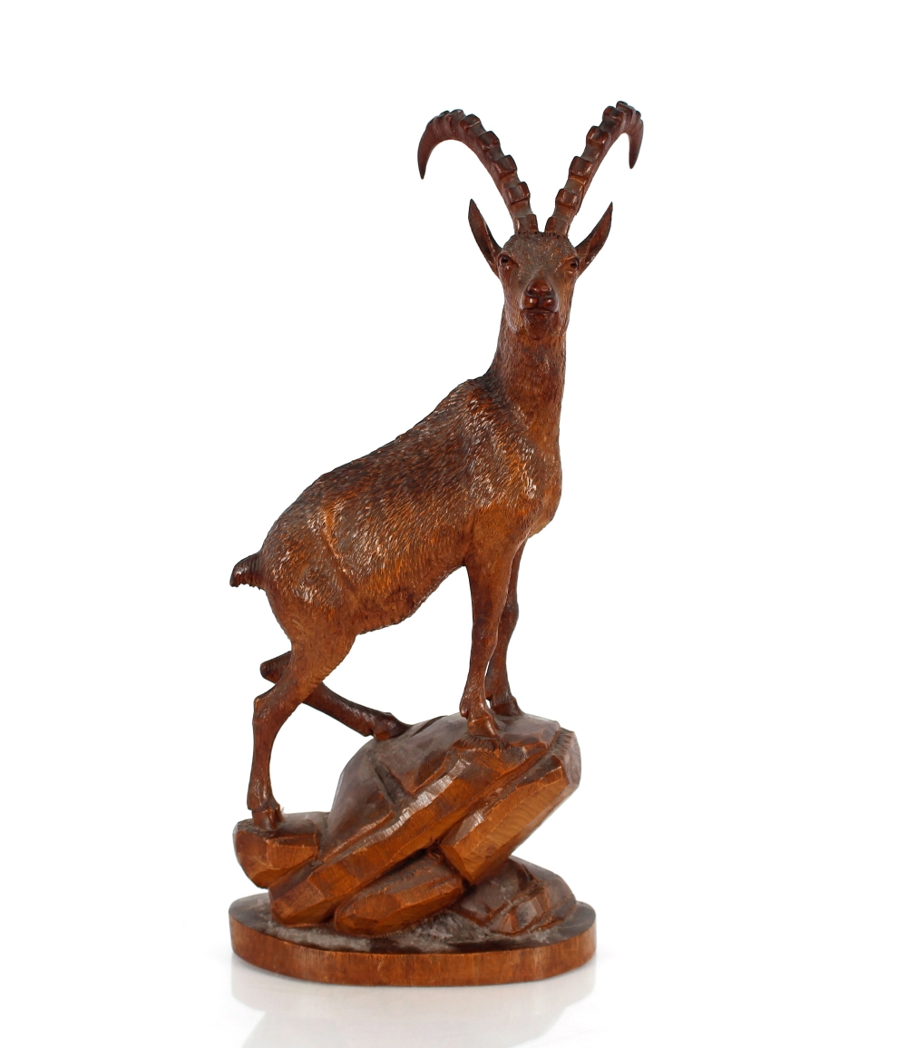 A Black Forest type carved wooden figure, of a mountain goat, 47cm high