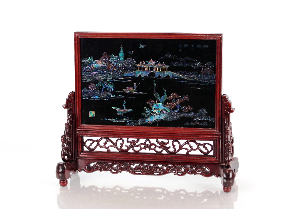 A Chinese carved hardwood and pieced table screen, decorated animals, lake, landscapes, bridge and