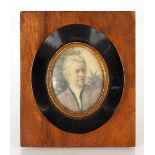 A late 19th / early 20th Century oval miniature portrait of gentleman in walnut and ebonised frame