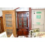 A late Victorian mahogany bookcase on cupboard bas