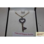 A Sterling silver and Tanzanite key pendant and ch