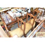 A set of six Edwardian carved walnut dining chairs