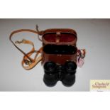 A pair of cased binoculars and miscellaneous racec