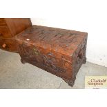 An Oriental carved camphor wood chest