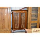 An early 20th century mahogany bookcase on cabriol