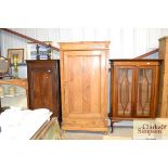 An old stripped pine wardrobe on single drawer bas