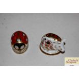 A Royal Crown Derby porcelain model of a pig with gold button mark and another of a ladybird also