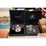 Four Swarovski Crystal boxed brooches and ear-ring