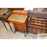 A Victorian walnut and inlaid Davenport writing de