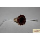 A 9ct gold and garnet set dress ring