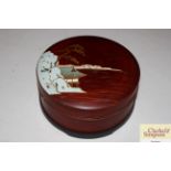 A circular Oriental lacquered trinket box with con