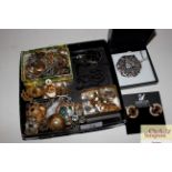 A box of various costume jewellery including brooc