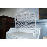 A white painted wrought iron crib