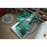 Two garden hose reels and hose