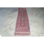 An approx. 7'6" x 1'8" Meshwani rug