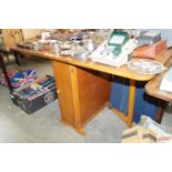 An oak drop leaf table with integral storage cupbo
