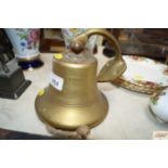 A brass bell and bracket
