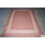 An approx. 7'5" x 5'4" red patterned rug