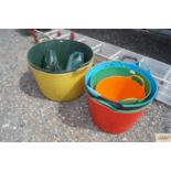 A collection of plastering buckets; two plastic wa