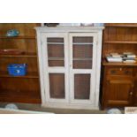 A painted pine cupboard with mesh doors