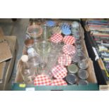 A box of various bottles and storage jars