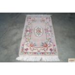 An approx. 4'2" x 2'3" Chinese style patterned rug