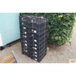 Twenty black plastic stacking crates