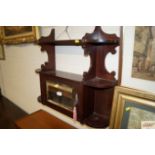 A mahogany hanging wall cabinet with mirror panel