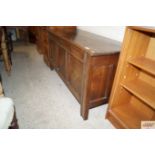 An antique oak coffer with inlaid panel front