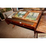 A reproduction mahogany drop leaf coffee table wit