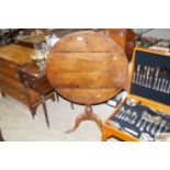 An antique oak tripod occasional table