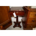 An antique mahogany work table