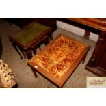 A teak tile top coffee table; and a nest of three