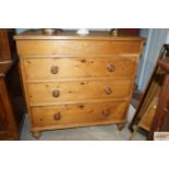 An antique stripped pine chest fitted four drawers