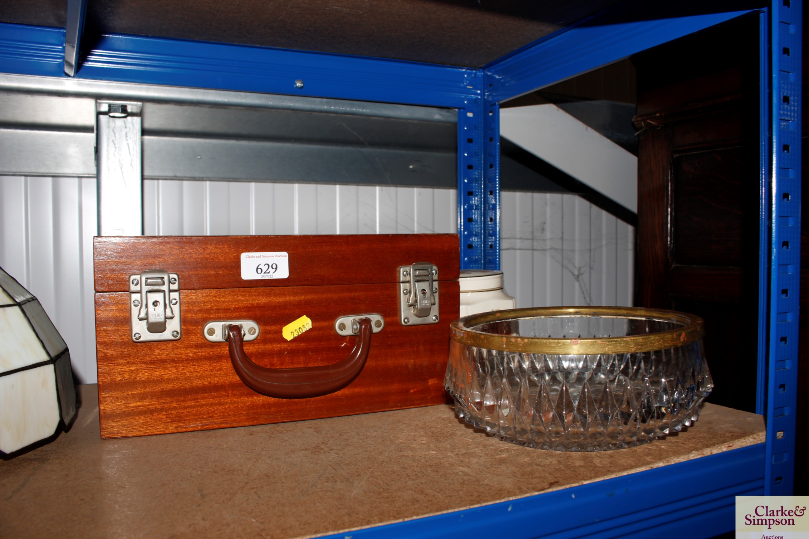 A wooden storage box together with a cut glass bow