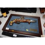 A framed reproduction Napoleonic cavalry pistol