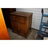 An Ercol style TV cabinet