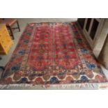 An approx. 9'3" x 6'8" red patterned rug