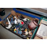 A box containing various action figures and toys e