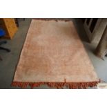 An approx. 8'10" x 5'2" orange patterned rug